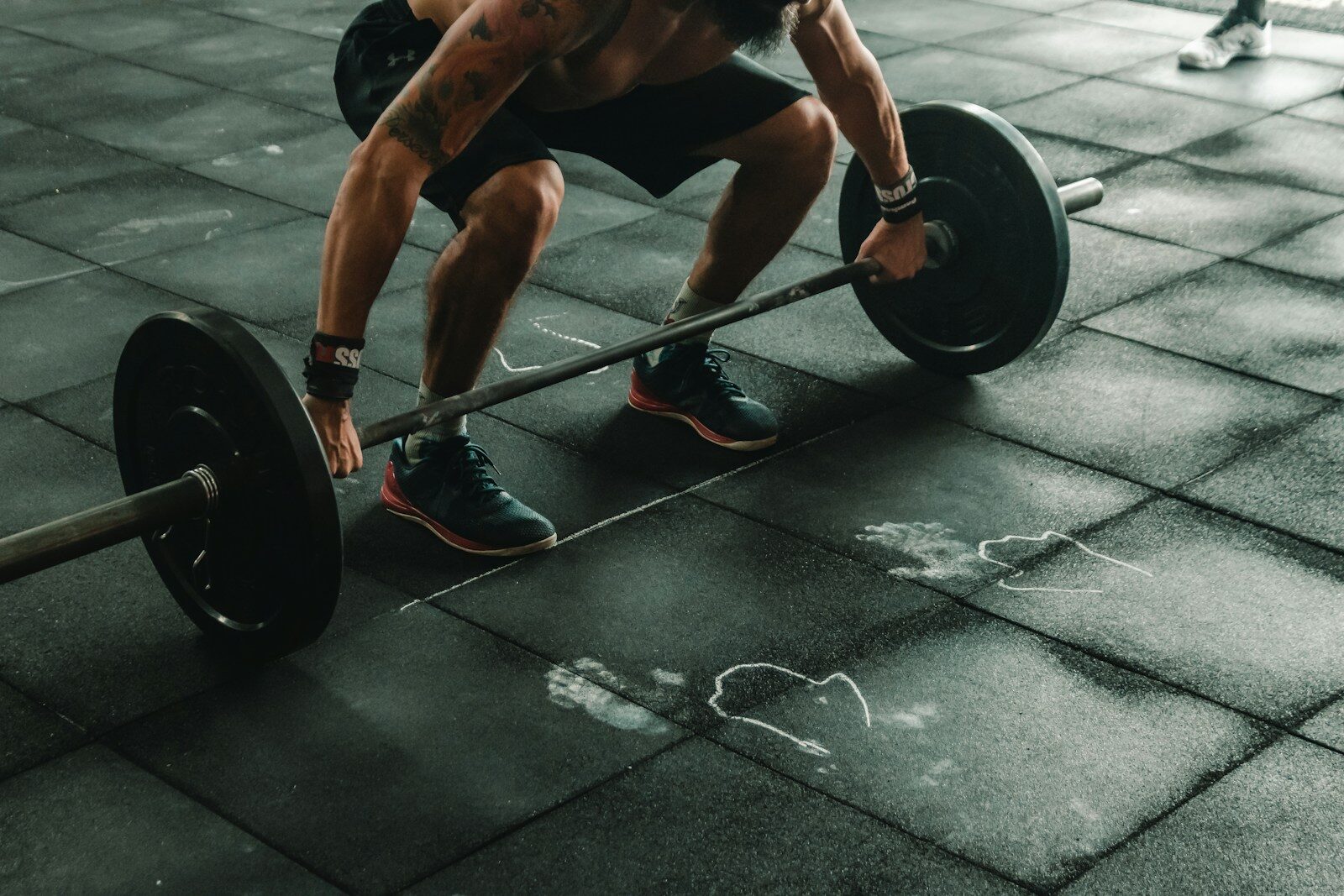 Photo by Victor Freitas man holding dumbbells